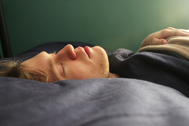 A person sleeping peacefully in bed.