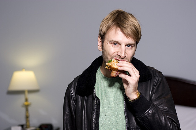 A person eating a sandwich.