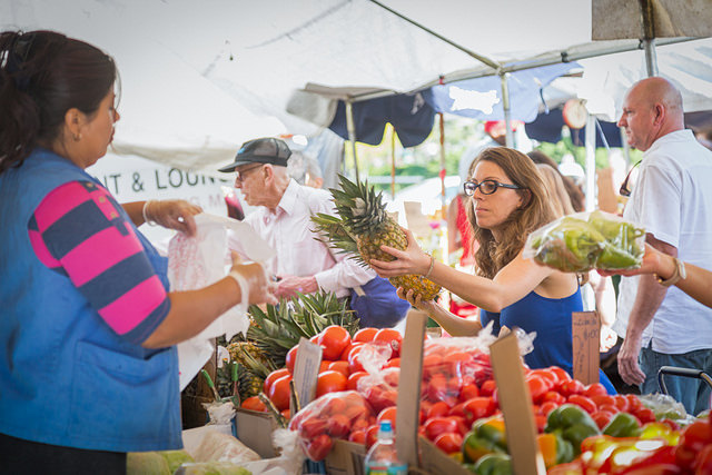 A bustling scene at the Copley Square Farmer's Market with fresh produce.