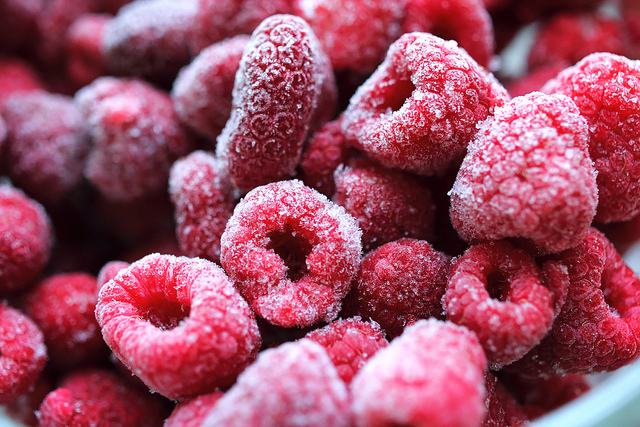 A variety of fresh winter produce on a wooden surface.