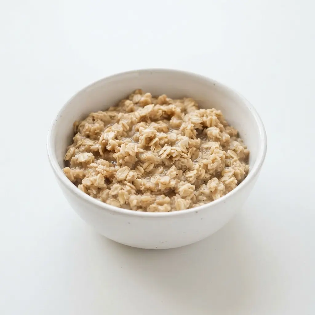 Oats in a plain white bowl on a clean white background.