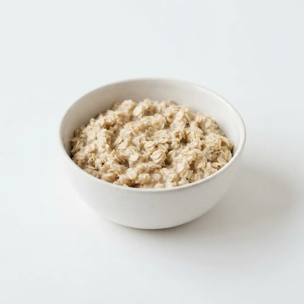 Rolled oats in a plain white bowl on a clean white background.