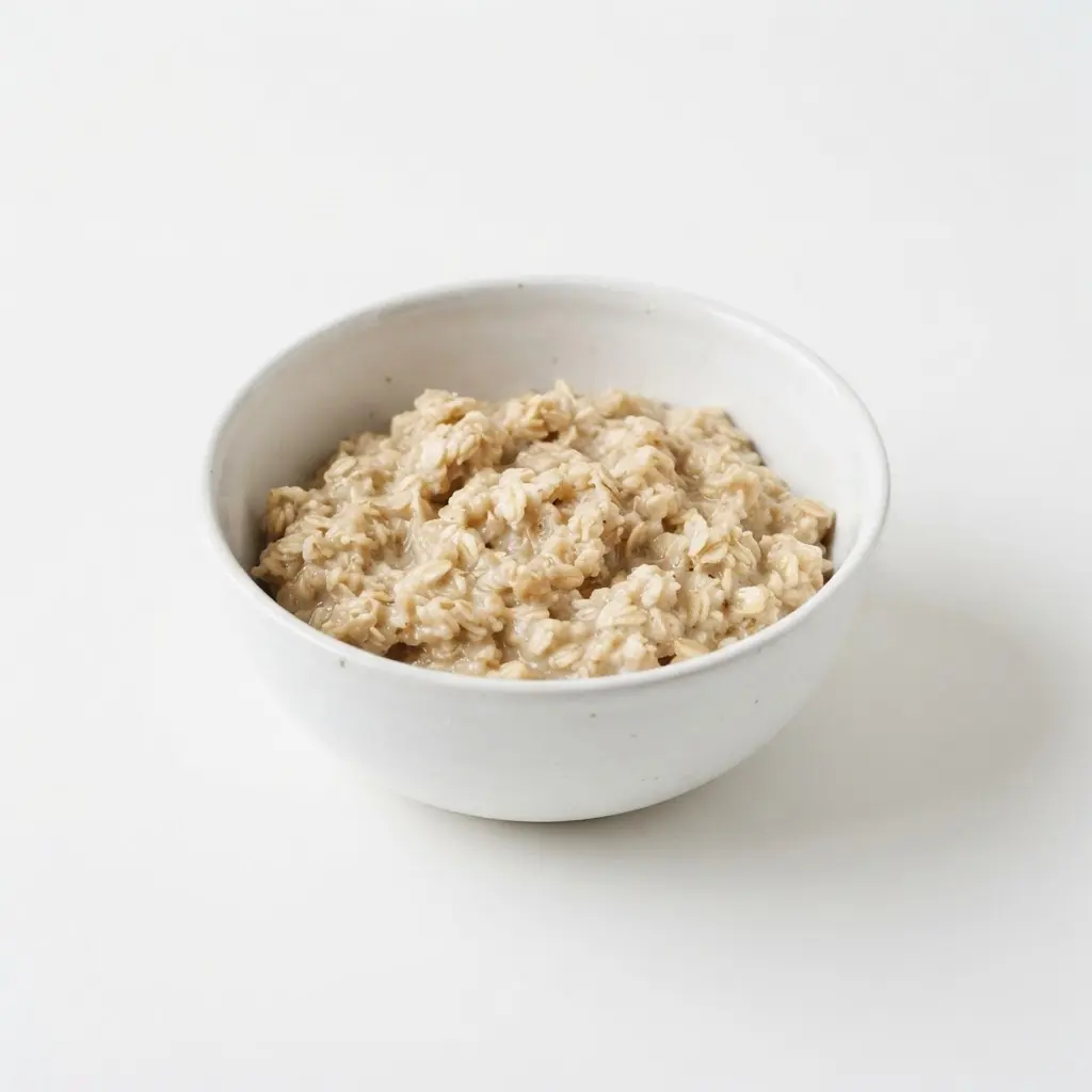 Oats in a plain white bowl on a clean white background.