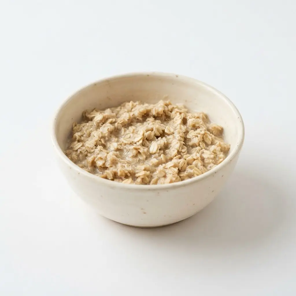 Rolled oats in a plain white bowl on a clean white background.
