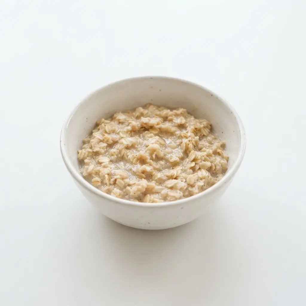 Oats in a plain white bowl on a clean white background.