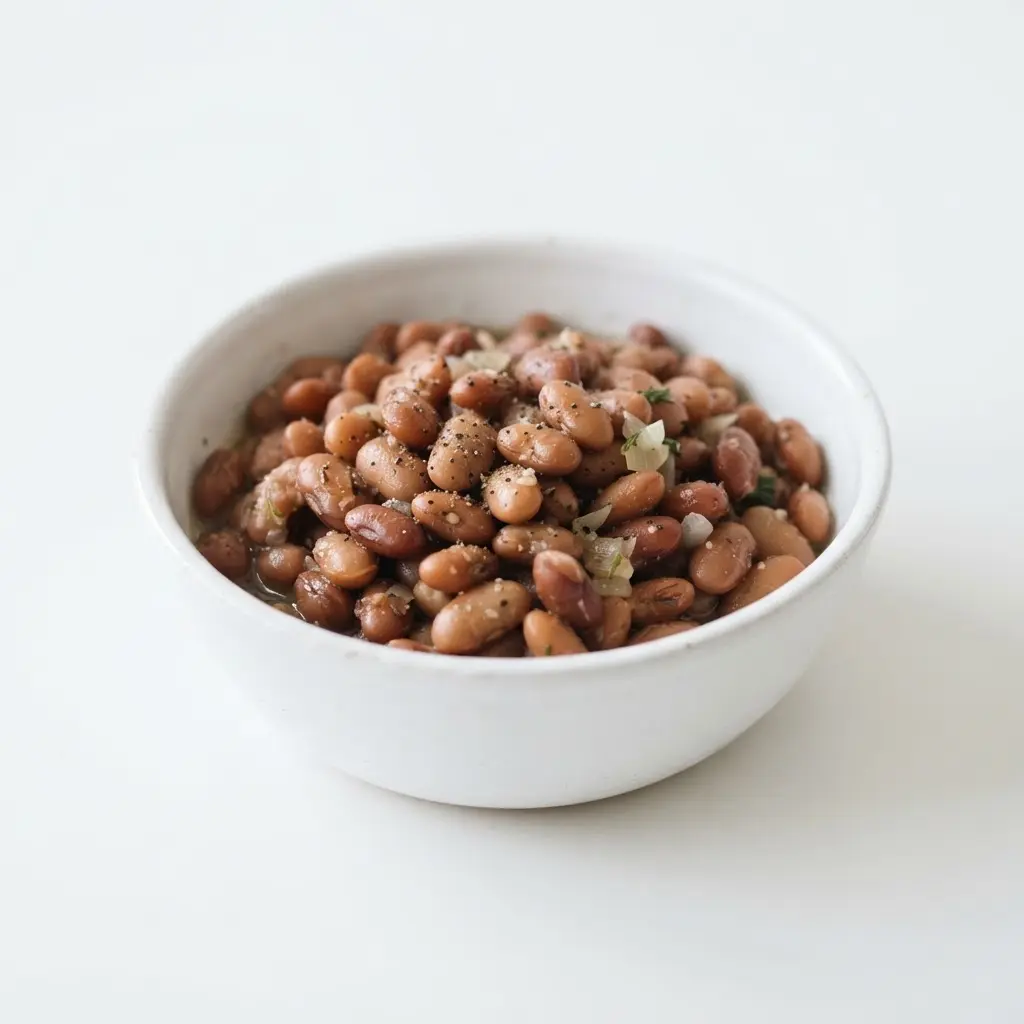 Beans in a plain white bowl on a clean white background.