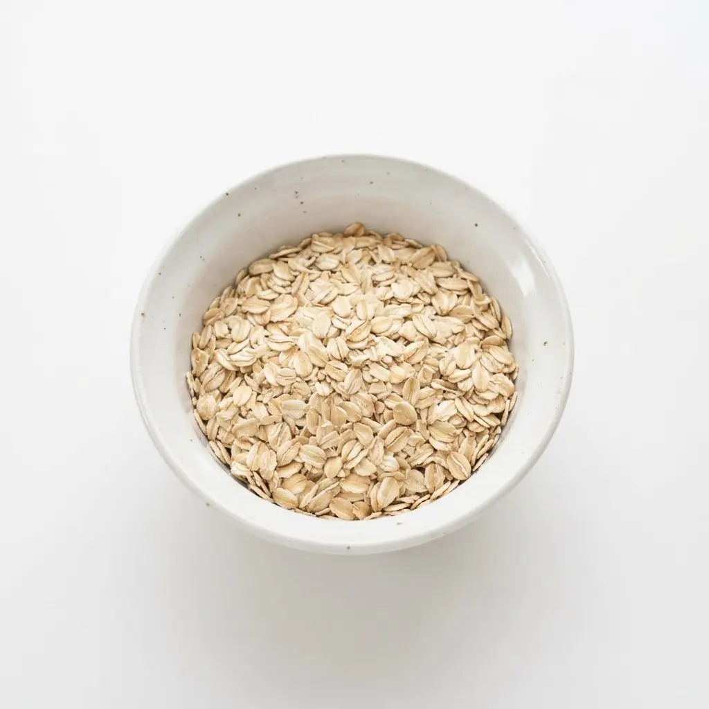 Rolled oats in a plain white bowl on a clean white background.